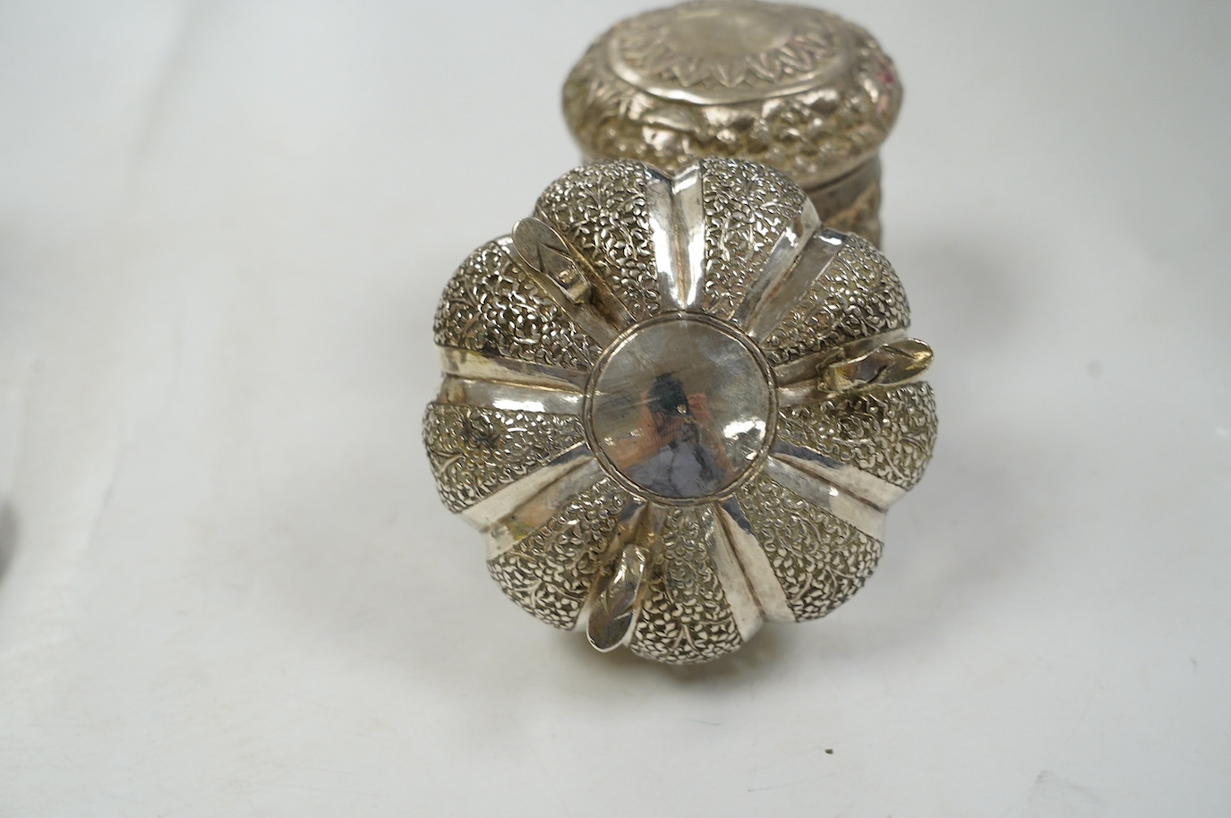 A pair of Indian pierced cusped white metal bowls, diameter 84mm, three other Indian white metal canisters and a Middle Eastern pill box. Condition - fair